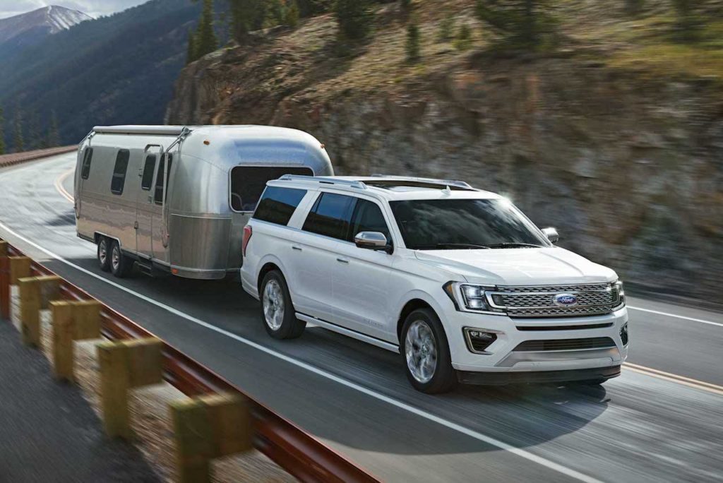 a white 2018 ford expedition pulling an airstream