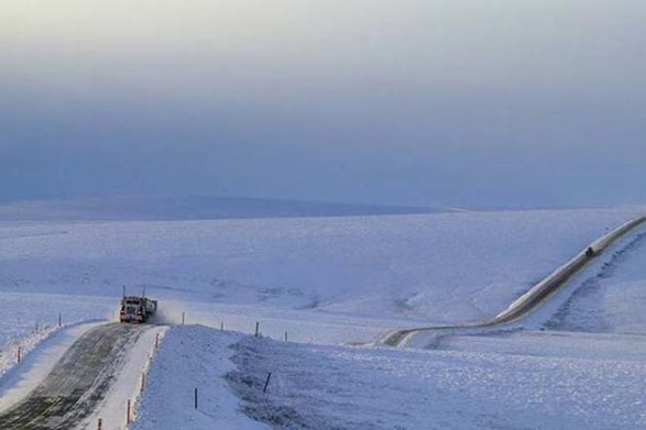 a barren snowy scene along the james dalton highway in alaska