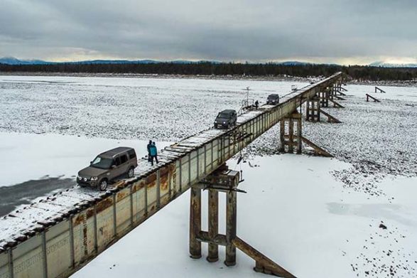 a view of the vitim river bridge over the frozen river in russia