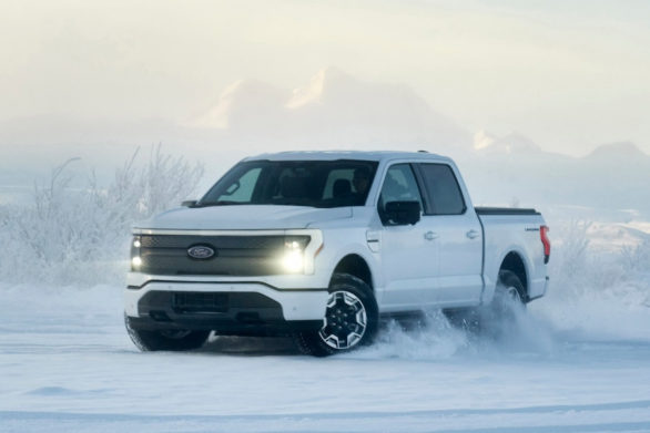 a ford f-150 lightning driving through the snow