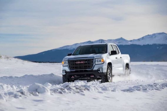 a white gmc canyon in the snow