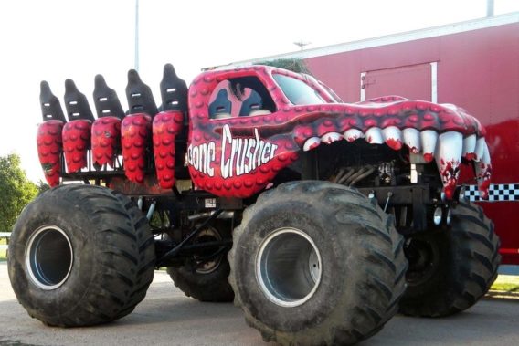 a lifted red truck with a hood shaped and painted to look like bloody teeth