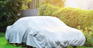 a car sitting outside under a car cover
