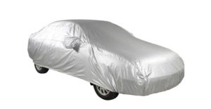 a silver car cover over a classic car