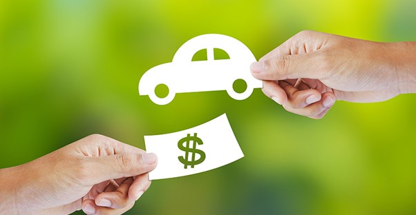 a paper cutout of a car and money symbolizing refinancing an auto loan