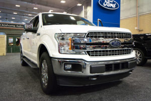 a white 2018 ford f-150 at an auto show