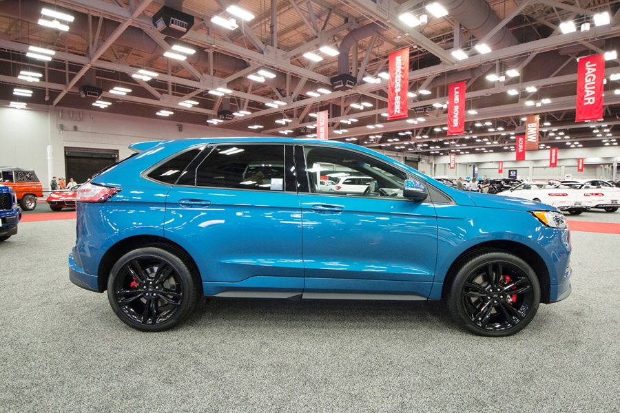 a blue 2019 ford edge at an auto show showroom