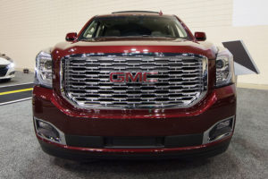 the front grille of a red 2019 gmc yukon
