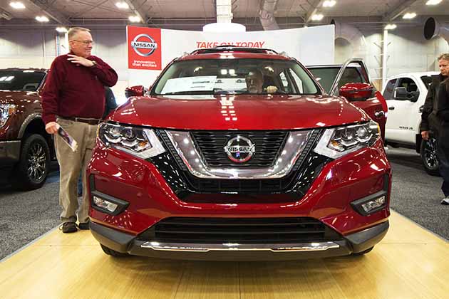 the front grille of a red 2018 nissan rogue