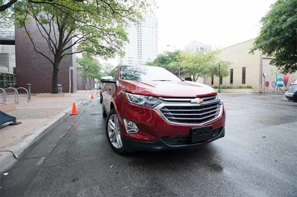 a red 2018 chevrolet equinox on the street