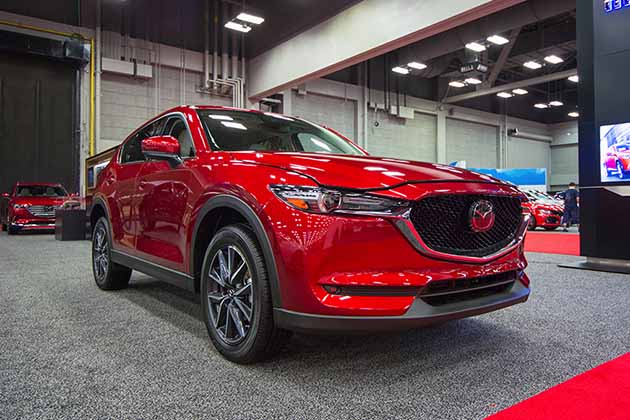 a red 2018 mazda cx-5 at an auto show