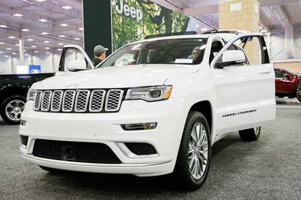 a white 2018 jeep grand cherokee at an auto show