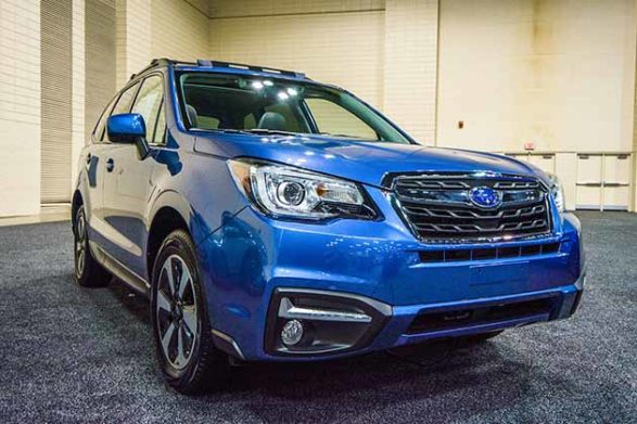 a blue 2018 subaru forester at an auto show