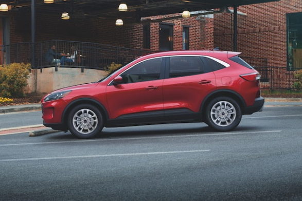 a red 2021 ford escape parked on the street