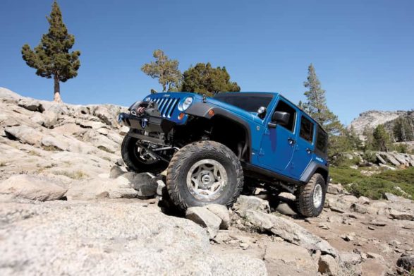 a jeep off road on rocks showing the flexibility of a body on frame design