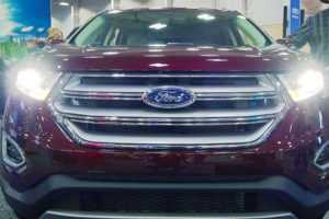 the front grille of a maroon 2018 ford escape