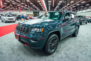 a dark gray 2018 jeep grand cherokee at an auto show