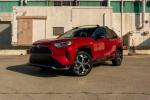a red 2021 toyota rav4 parked in an industrial setting