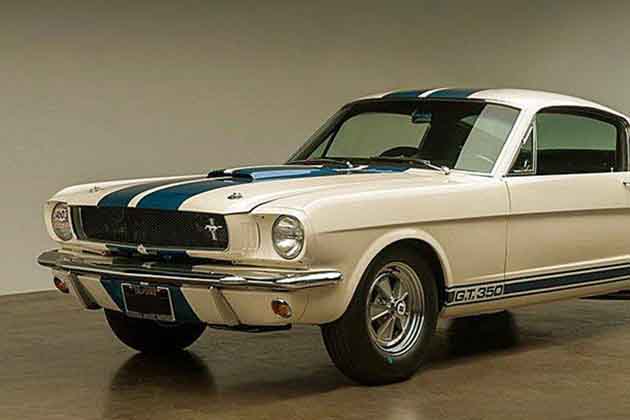 a white shelby mustang with blue racing stripes