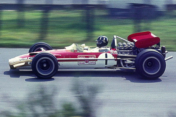a driver racing a lotus 49 on a track