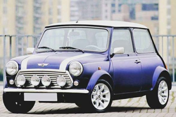 a purple bmc mini with white racing stripes and white roof