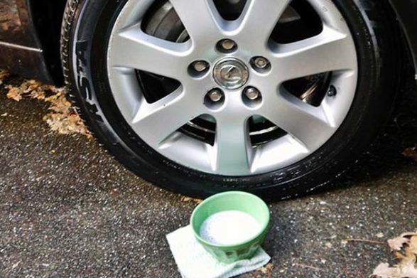 a bowl of homemade diy car cleaner in front of a tire