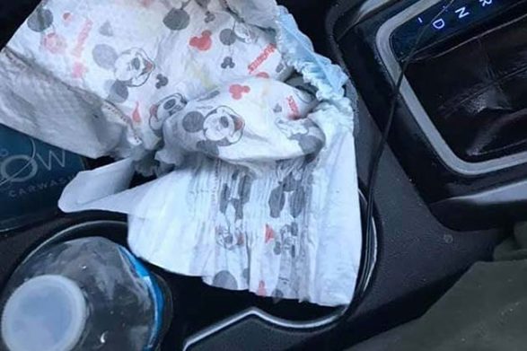a diaper in a car cup holder