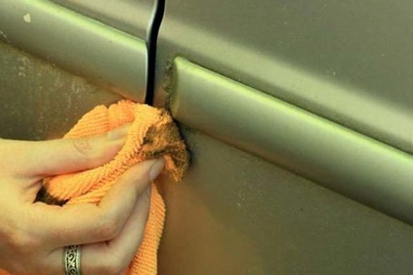 a cloth wiping the outside of a car with mayonnaise to remove stains