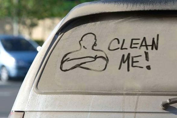 an image of mr clean drawn in the dirt on a car window