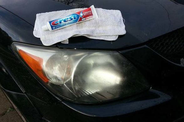 a toothpaste bottle on top of a car headlight
