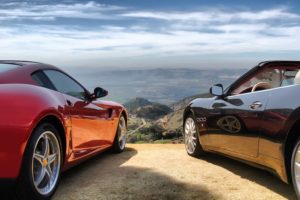 two corvettes in front of an expansive landscape symbolizing a long road trip