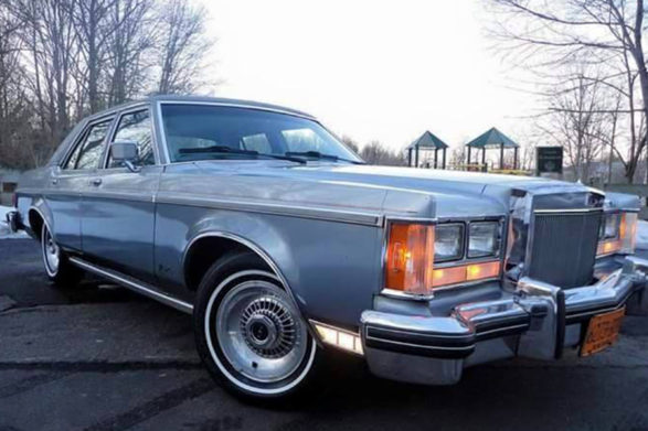 a silvery gray 1977 lincoln versailles