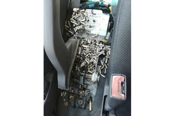 a car center console covered in cigarette butts