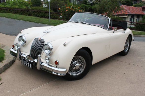 a white 1950 jaguar xk150