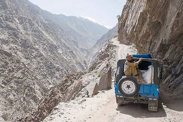 an suv attempts to make its way along the narrow gravel road of the nanga parbat pass in pakistan