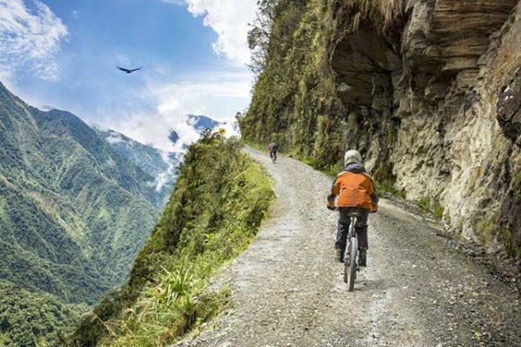 bikers travel along the yungas road in bolivia