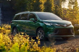 a forest green 2021 toyota sienna in a forest