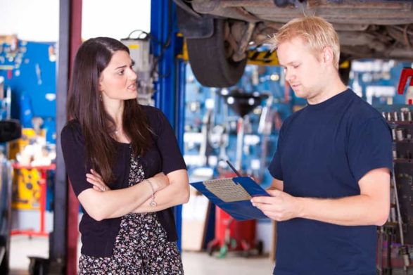 a mechanic gives a verbal estimate to a female customer