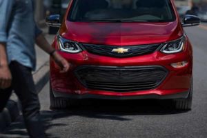 the front grille of a red 2020 chevrolet bolt