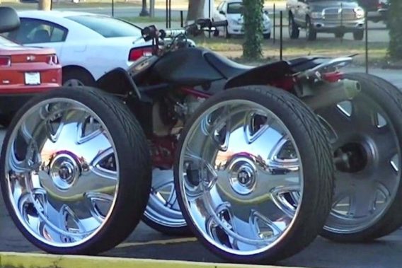 an ATV with oversized wheels and fancy shiny rims