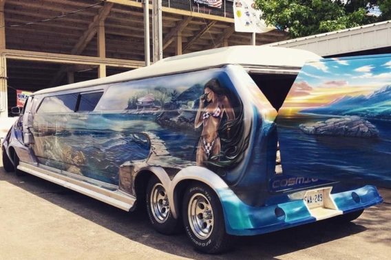 a van with a beach landscape and bikini woman painted on the side
