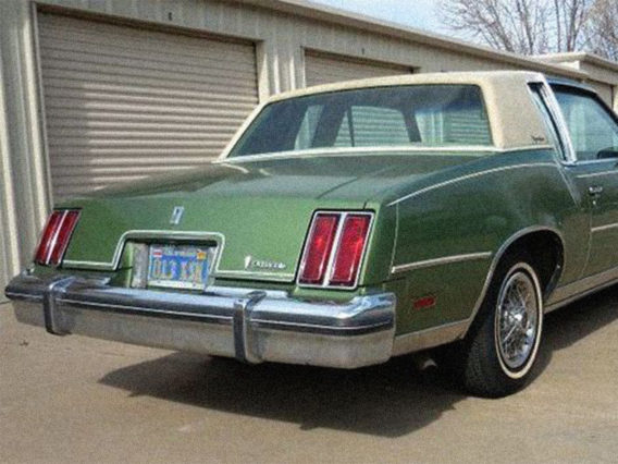 the tail end of a green oldsmobile cutlass supreme diesel