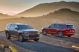 two jeep grand cherokee L models, one dark gray and one red