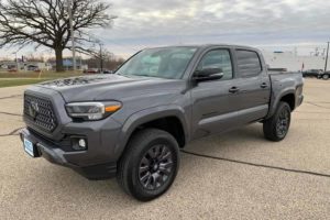 a dark gray 2021 toyota tacoma in a dealer lot