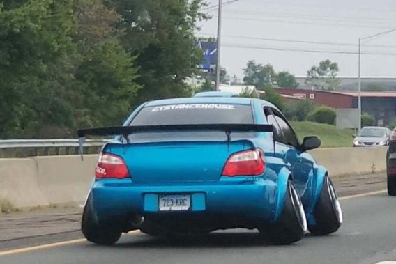 a low riding car with tires tilted into the wheel well