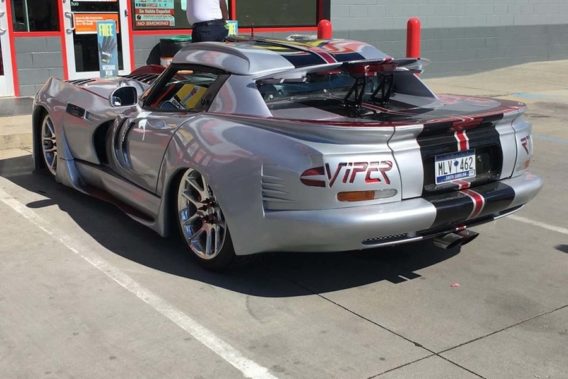 a heavily customized dodge viper with extra aerodynamic scoops along the sides, roof, and hood