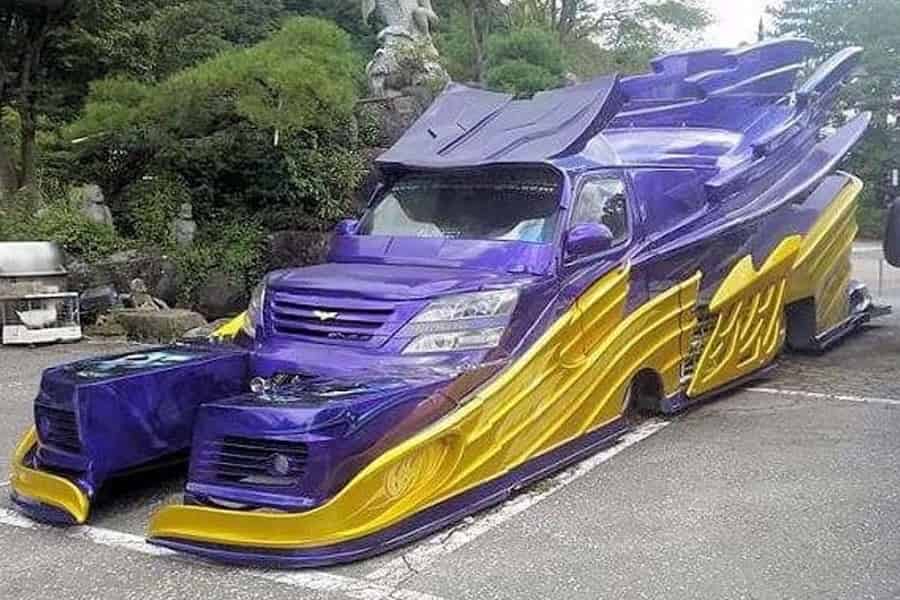 a purple and yellow van that has been heavily modified to look like a transformer