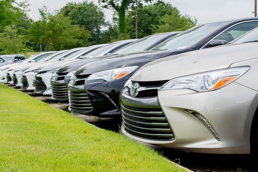 a row of used cars at a car dealer